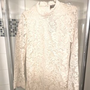 Lace dress lined body but skin peeks through the sleeve portion